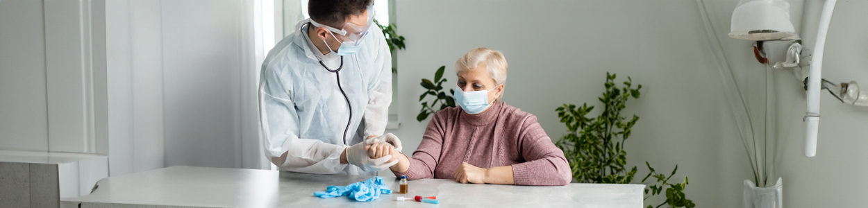 Doctor Taking Blood Test Of Alzheimer Patient