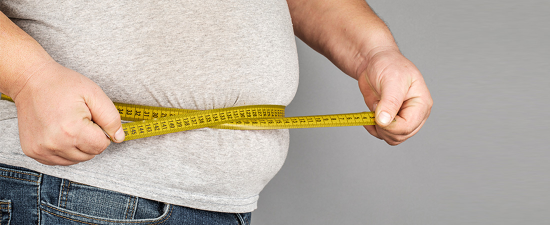 Man Measures His Fat Belly with a Measuring Tape